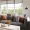a couch with pillows and a coffee table with trinkets on it