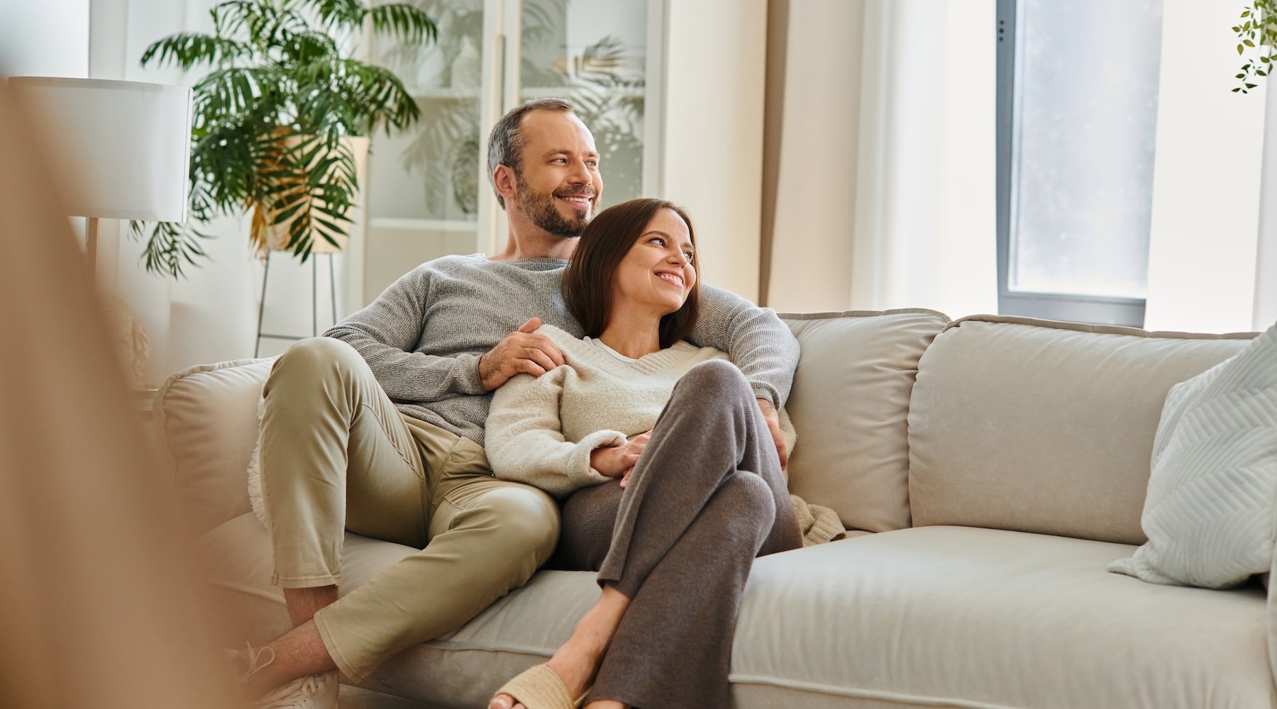 Generous living spaces to relax and unwind a couple sitting on a couch together