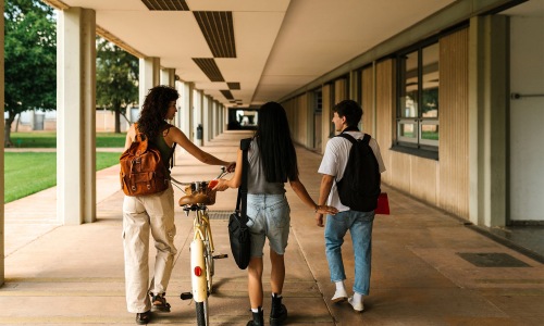a group of people walking down a sidewalk